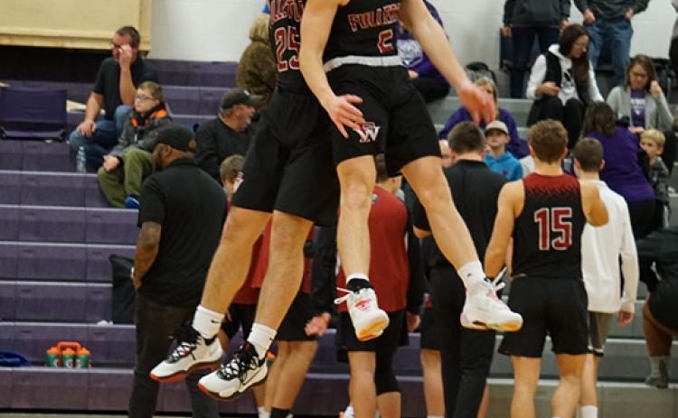 Seniors Jaxson Sullivan and Brady Cook jump to get the team fired up before the game. Photo by Laura Sabata