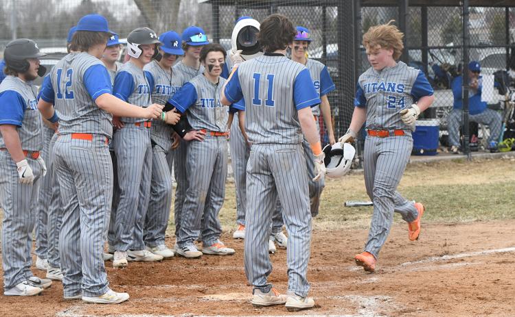 Twin River's bench gathers around home plate as Paydon Rinkol rounds the bases following his second inning two-run home run. NCJ photo by Rick Holtz