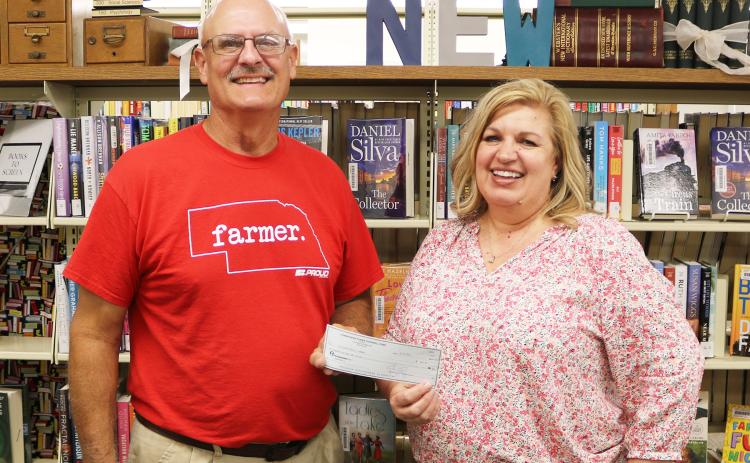Cornhusker Public Power District Trustee Marc Swantek (left) presents $200 to Fullerton Public Library for an electric tankless hot water heater.  Accepting the check is Library Director Laurel Marlatt. Photos provided