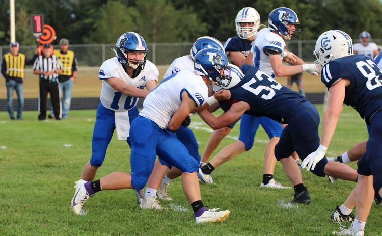 Kadin Buhl fakes the handoff to Landyn Roebuck on Friday against the Cougars. NCJ photo by Travis Lane