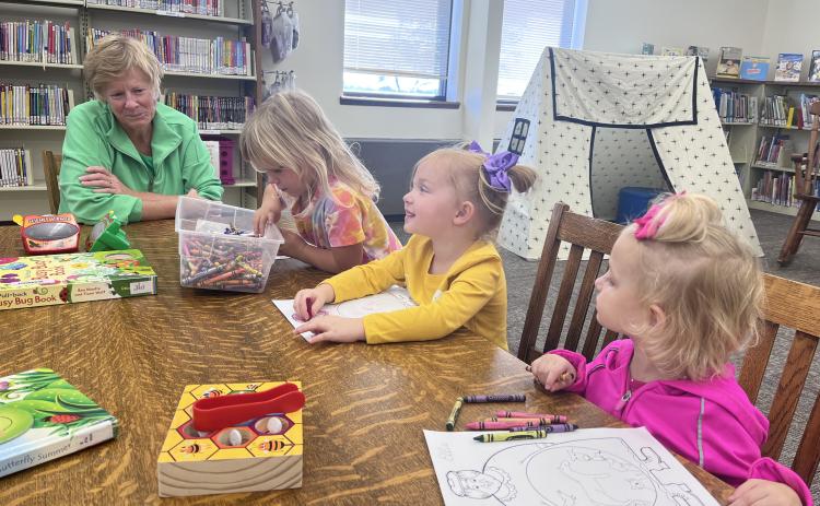Mary Pat Nathan (left), Blair Boryca, Harlow Wetovick and Ellie Carr work on a craft at the Fullerton Library. NCJ photos by April Carr