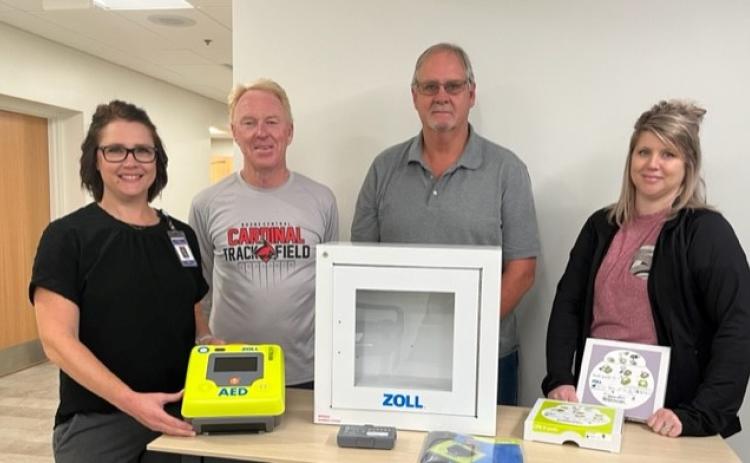 Amy Olnes, APRN, FNP-C presents AED to church council members Tom Dickey, Chris Nelson and Sara Rasmussen. Photo provided