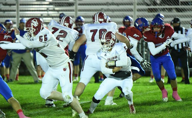 Fletcher Dubas runs the ball in Fullerton's final game of the regular season. The Warriors open the playoffs on Thursday at Humphrey when they take on St. Francis. NCJ photo by Rick Holtz