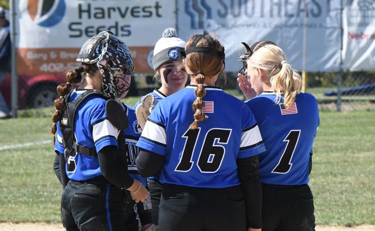 The Titans talk things over during the first game at the district final on Friday. NCJ photo by Rick Holtz