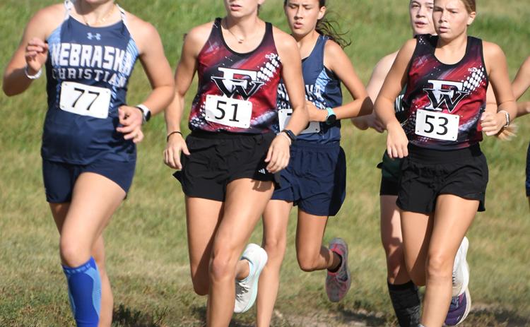 Makayla Robinson and Morgan Supik help push each other early on in Thursday's race. NCJ photo by Rick Holtz