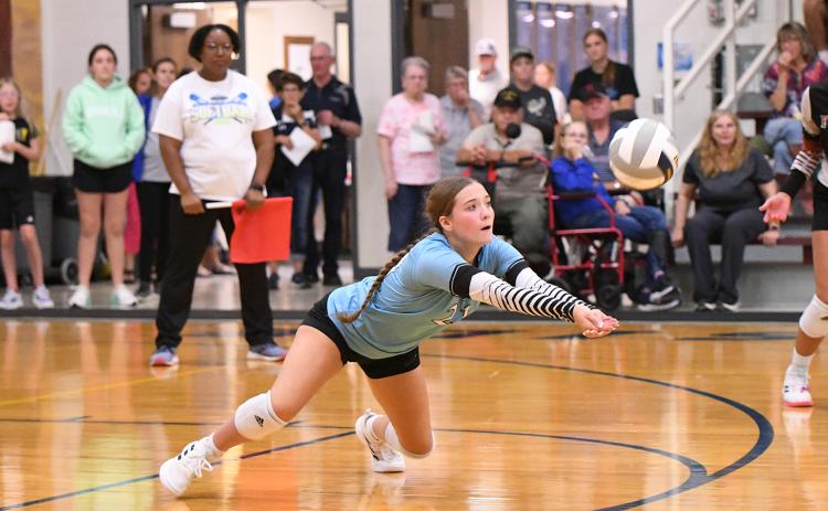 Tylar Konwinski makes a diving save against Riverside. She had 7 digs against the Chargers. NCJ photos by Rick Holtz