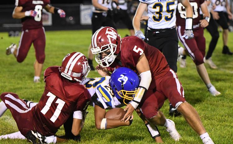 Fletcher Dubas and Kyle Horn converge on the ball to stop the Knight's offense. NCJ photo by Calvin Holtz