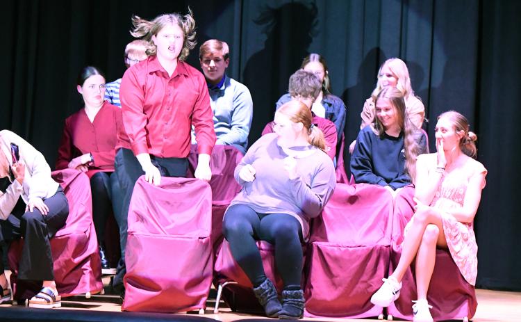 Augden (played by Colton Harris) has a little trouble getting comfortable in his chair after trading seats with Ashley (played by Kinzie Sharman) in Fullerton’s play production “Appropriate Audience Behavior.” The community is invited to a performance on Friday, Nov. 15 in the school gymnasium. NCJ photos by Rick Holtz