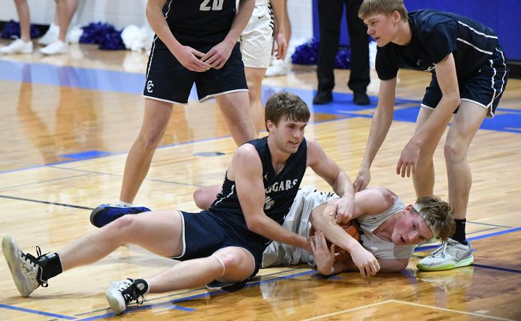 Lane Lund puts his body on the line for a loose ball against Cross County. NCJ photo by Rick Holtz