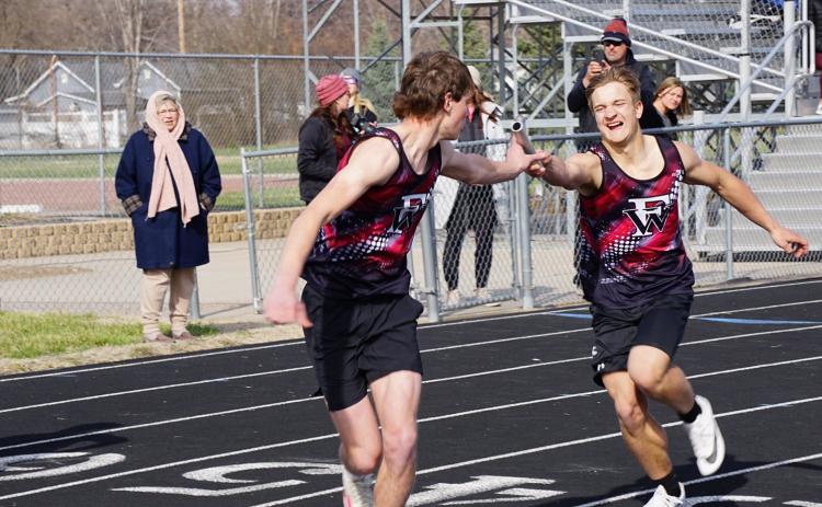 Cael Dubas makes the exchange with Nolan Dubas in the 4x100-meter relay at Burwell. NCJ photo by Cathy Cook