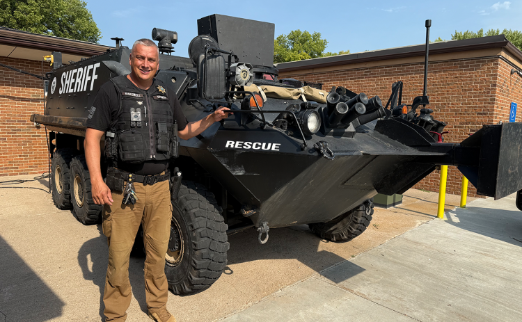 Nance County Sheriff Ben Bakewell stands next to the Special Response Team’s new armored vehicle. The team can use the 12.8 ton, 8-wheeled Stryker to execute high-risk search warrants or a water rescue. NCJ photo by Rick Holtz
