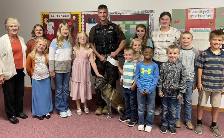 Fullerton Community Church Sunday School class poses with Deputy Woollen and Zina Photo provided