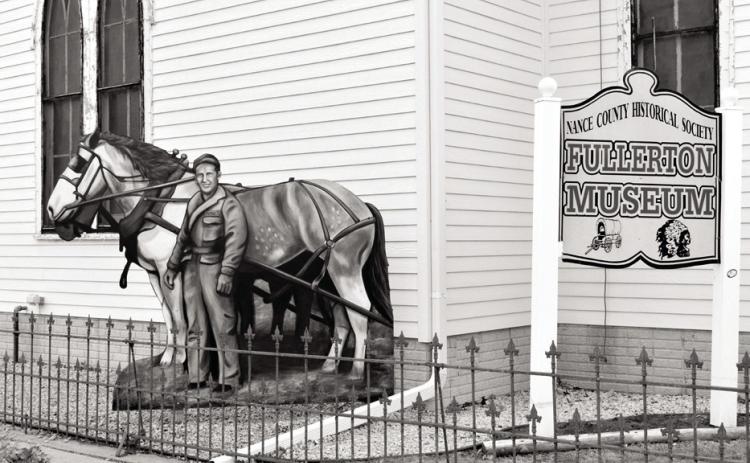 The above artwork located at the front of the Fullerton Museum was created by Marah Sandoz of Taylor, Nebraska. It is a rendition of a photo of Karl Koziol, the father of Andrew Koziol of Fullerton. Assisting in the installation of the artwork were Jon Epley, Dennis McCoig, and Clay Koziol who is Karl’s grandson. Journal photo