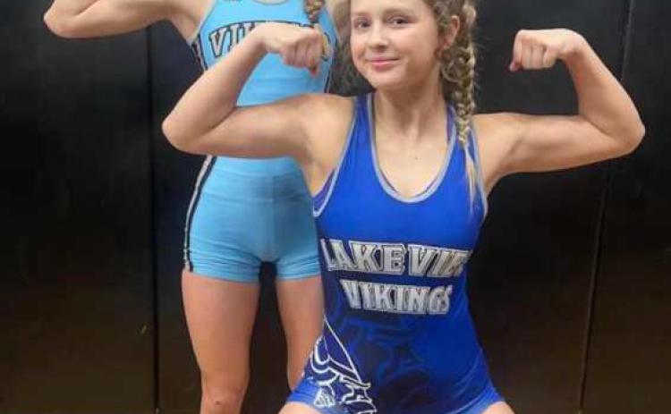 Sister, Sister - CALLIE HELD (back) LIBBY HELD (front) celebrate after punching their tickets to Girl’s State Wrestling. Callie is a freshman and Libby a junior. They are the daughters of Jamie and Jamie Held.