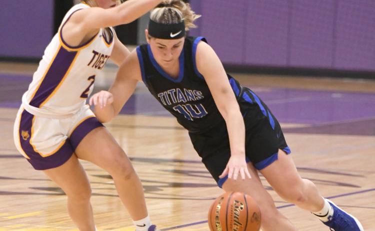 Delaney Reeg fights to push the ball against the Tiger pressure defense in the first half. NCJ photo by Rick Holtz