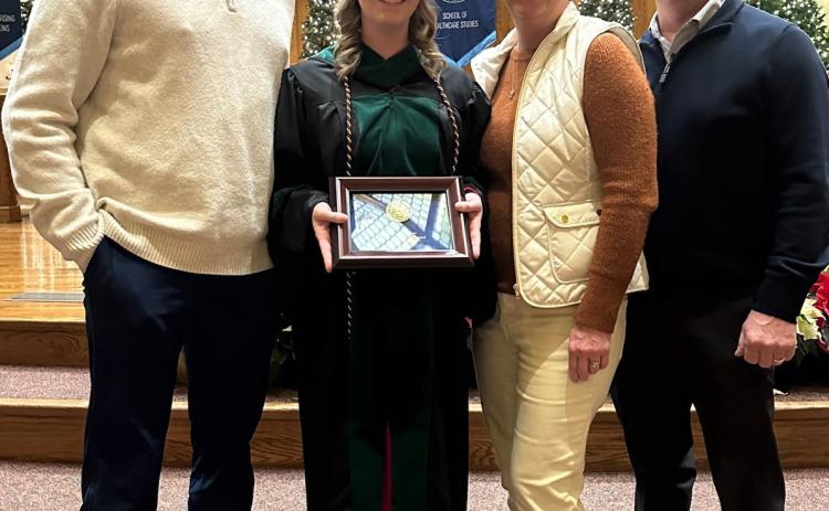 Dr. Kramer with her husband Kyle and parents John and Tracy Beckman following her Early Career Alumni Award recognition. Photo provided