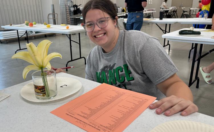 ABOVE: Melinda Pickrel of Fullerton completes her horticulture judging project Tuesday morning.