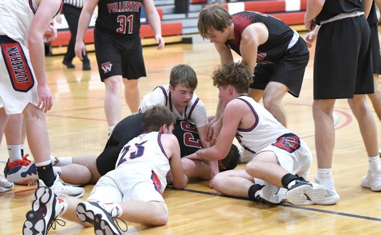 Kenton Dudek dives for a loose ball during the second half of Saturday’s game. NCJ photo by Calvin Holtz