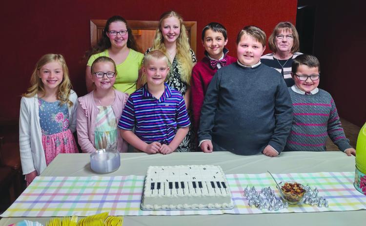 Kitten on the Keys Music Studio presented a piano recital for family and friends on Sunday, April 23 in the First National Bank Community room. Students played solos and duets. Pictured are (front row) Molly Dubas, Paisley Jazwick, Jacob Reimer, Brady Carr, Hudson Carr; (second row) Melinda Reimer, Elena Reimer, Jackson Carr and teacher Leta Liesch. Photo provided