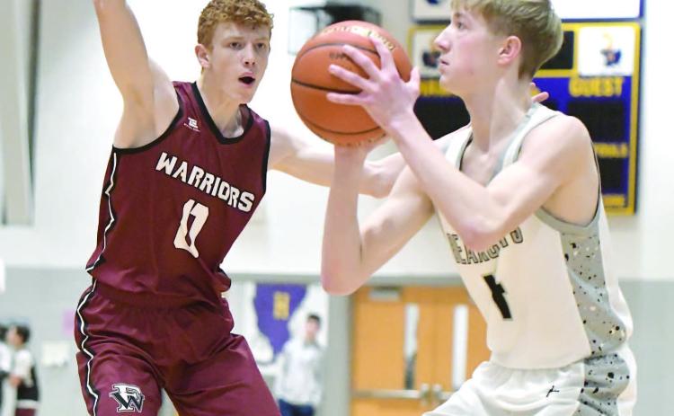 Jacob Maxfield plays tight defense during the first quarter of Fullerton's game against Hampton/Heartland.