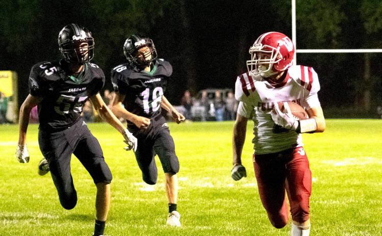 Isaac Supik finds room on the sideline on his way to a touchdown. NCJ photo by Melissa Aaberg