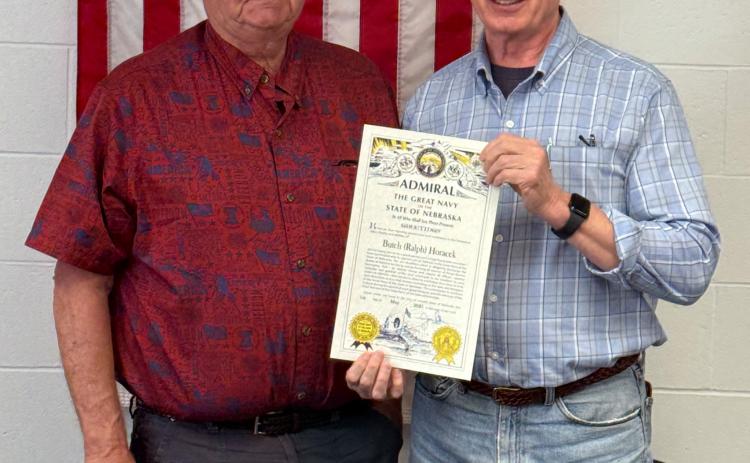 Butch Horacek (left) was surprised Tuesday morning with an announcement that he was being named a Nebraska Admiral. State Senator Loren Lippincott presented the honor during the Nance County Board of Supervisors meeting. NCJ photo by Rick Holtz