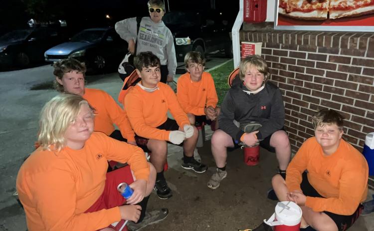 Logan Padula (left), Kolt Francis, Riley Williams, Axel Collins, Kyle Horn, Richard Trask, Colton Harris wait to be picked up at Casey’s. NCJ photo by April Carr