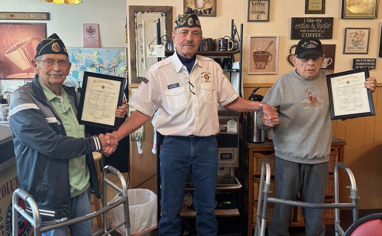 Denny Backman (left) and Bob Patrick were presented with framed certificates recognizing them for 50 years of continuous membership to the American Legion. Genoa Post Commander John Buhl presented the men with the honors on Thursday at Fill My Cup in Genoa. NCJ photo by Rick Holtz