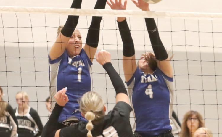 Tricia Kunkee and Jaclyn Everett go up for a block at the net against Hampton-Heartland. NCJ photo by Ken Kush