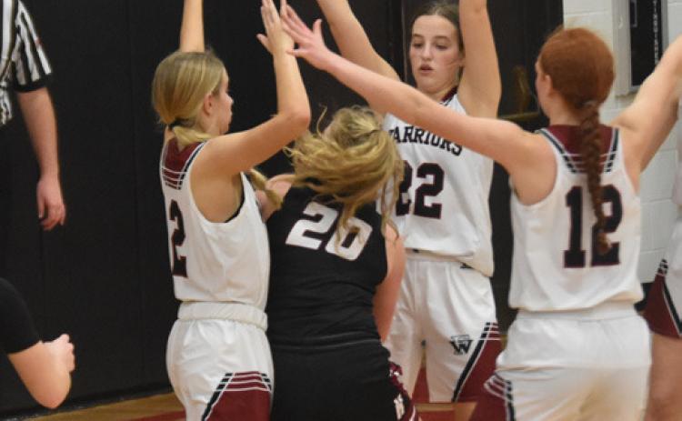 Pictured above: Paige Horn, Isabel Norman, and Julianna Maxfield blocking the opponent from all sides Picture by Carla Wetovick