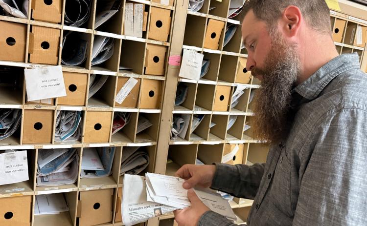Fullerton Postmaster Tom Bates sorts mail ahead of the holiday rush. NCJ photo by Rick Holtz