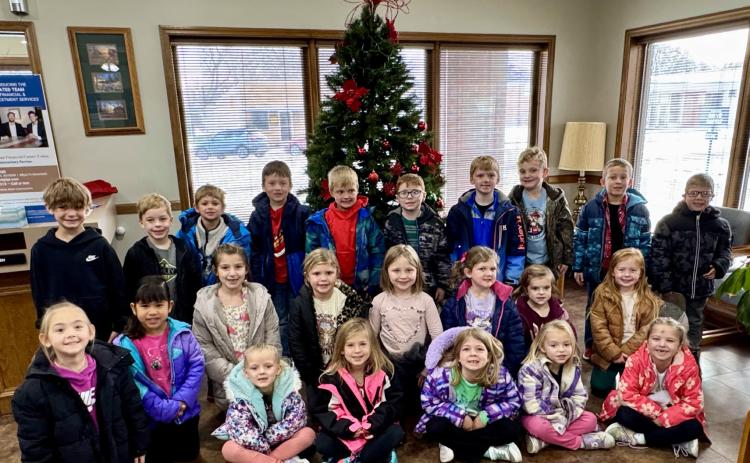 Kindergarten decorates tree at bank