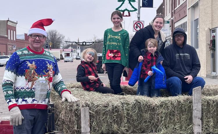 Dallas Schweitz prepares to drive the hayrack rides with the Hodgman family (Nate, Jaylie, Sarah, Paisley, Lincoln) in tow.