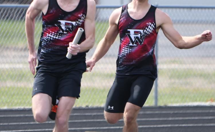 Kane Wetovick takes the baton from Fletcher Dubas is the 4x100-meter relay. NCJ photos by Rick Holtz