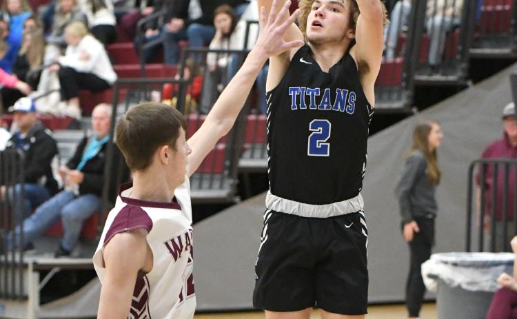 Kadin Buhl knocks down a long-range shot in the second quarter for the Titans. The senior finished with 5 points in the contest. NCJ photo by Rick Holtz