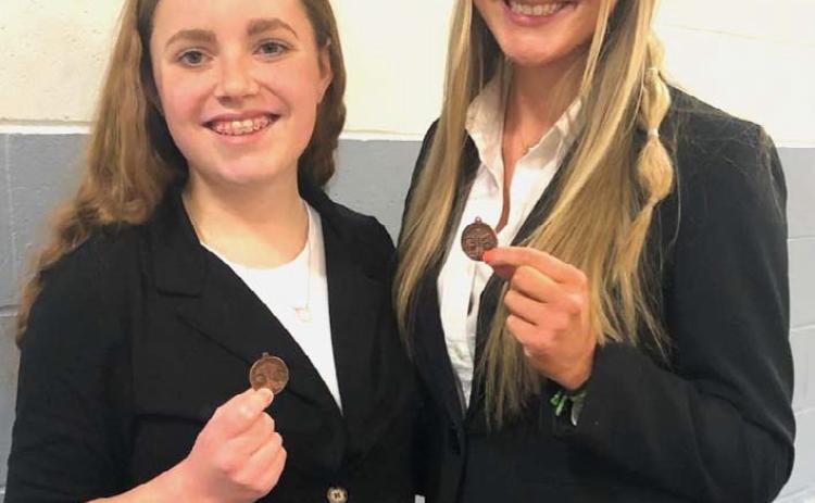 Pictured on the left: District medalists from L: Peyton Thomas, Kristine Chmiel