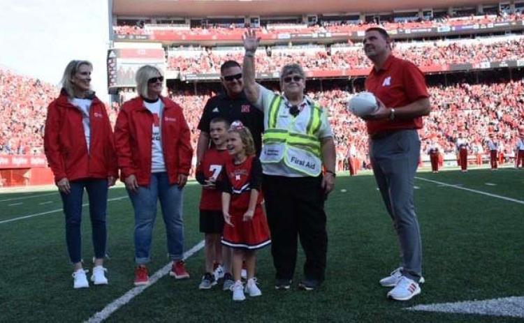 PATTY MORGAN was awarded the 2022 Red Cross Volunteer of the Year. Her family was able to attend the game and watch as she was awarded a football signed by Coach Joseph. Photo courtesy of American Red Cross.