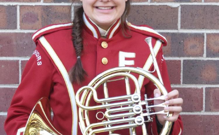 Lylla Sabata stands with her french horn. Photo by Laura Sabata